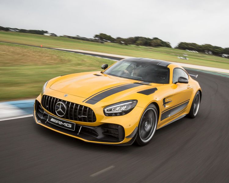 a yellow mercedes gtr on a race track during a driving experience day