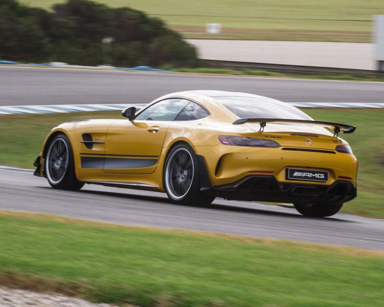 a yellow mercedes gtr on a race track during a driving experience day