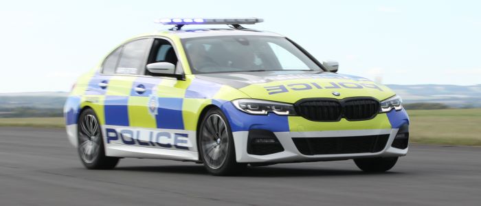 a uk police car driving along a track for a police car driving experience