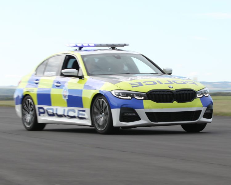 a uk police car driving along a track for a police car driving experience