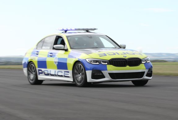 a uk police car driving along a track for a police car driving experience
