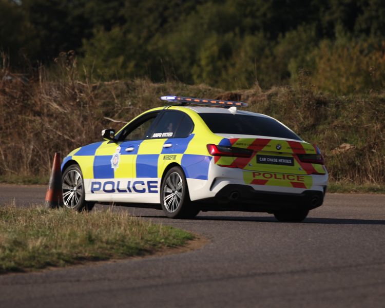 a uk police car turning a corner on a track during a police car driving experience