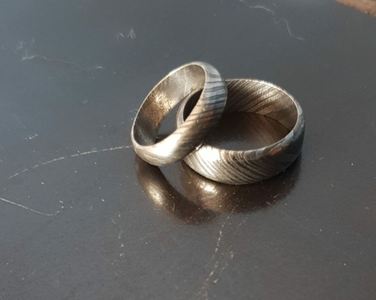 two patterned damascus rings made on a damascus ring making experience day