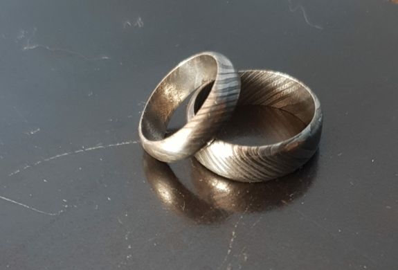 two patterned damascus rings made on a damascus ring making experience day