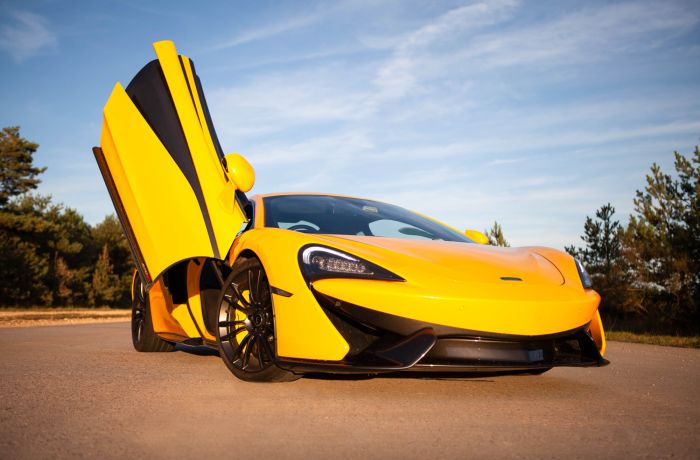 yellow supercar with drivers door lifted up at car chase heroes driving experience day