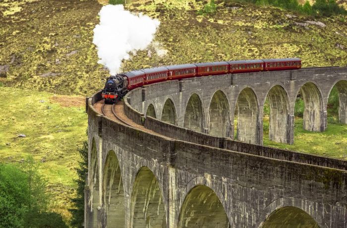 The jacobite steam train crossing the glenfinnan viaduct in the west coast of scotland...