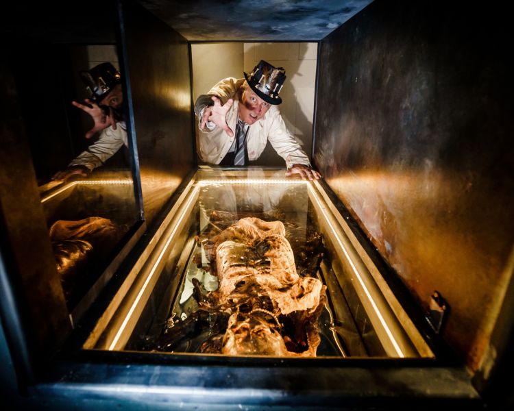 man looking down into a basement at the house of frankenstein in bath