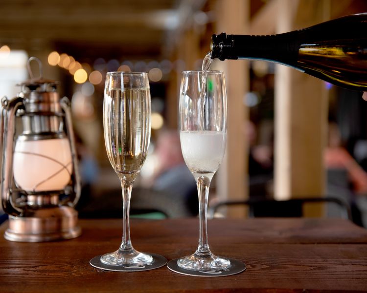 two glasses of prosecco on a bar at a glamping site in dorset
