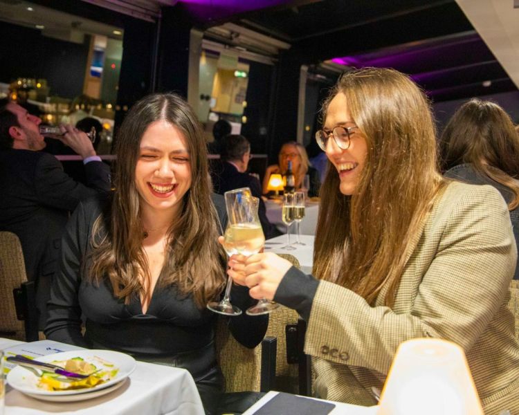 Two guests dining on the Murder Mystery river cruise