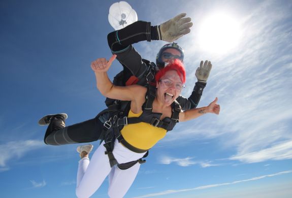 a woman on a tandem skydiving experience during freefall