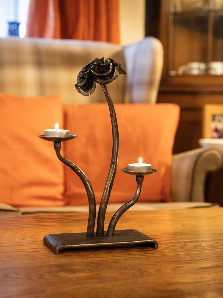 a cast iron rose tealight holder made on a blacksmith experience