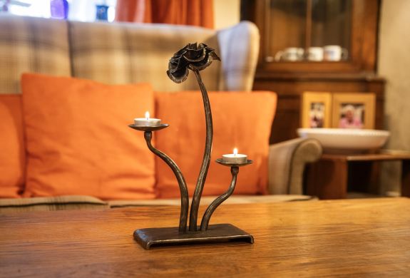 a cast iron rose tealight holder made on a blacksmith experience