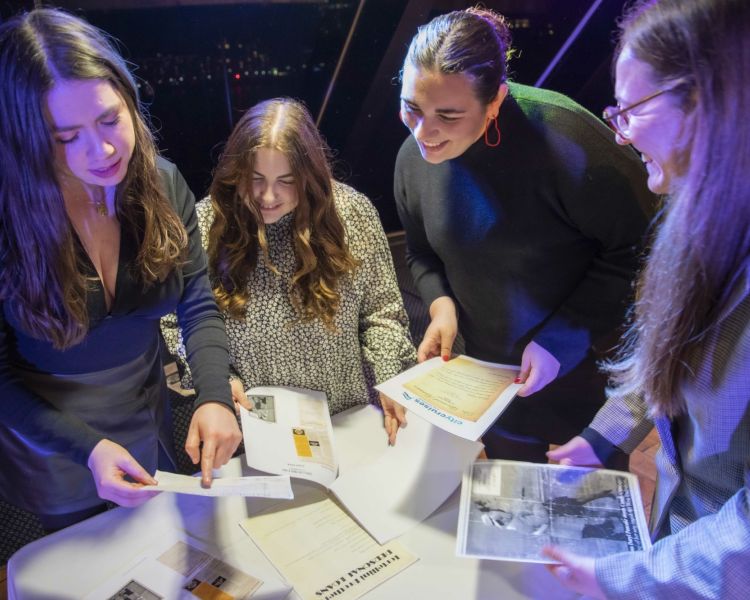 Girls Reading Clues on the Murder Mystery river cruise