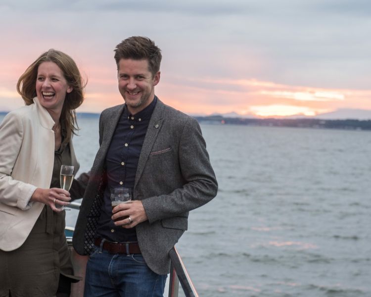 couple on the deck on a cruise boat on an evening themed sightseeing cruise in scotland