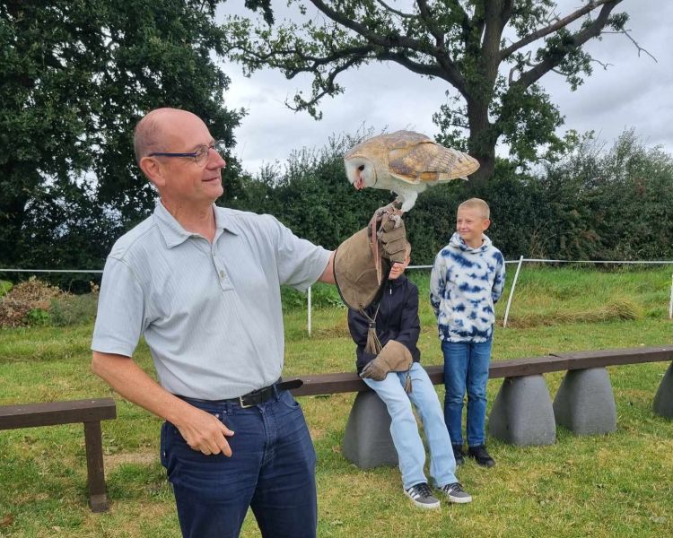 Man holding a barn owl