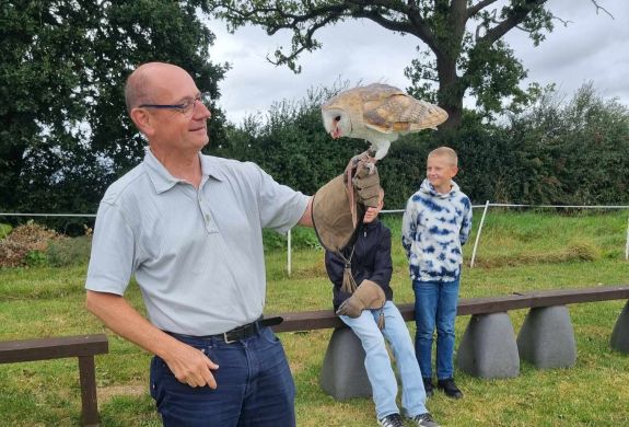 Man holding a barn owl