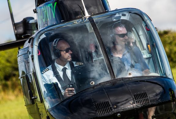 the front view of a helicopter taking off for a tour as part of a helicopter experience day