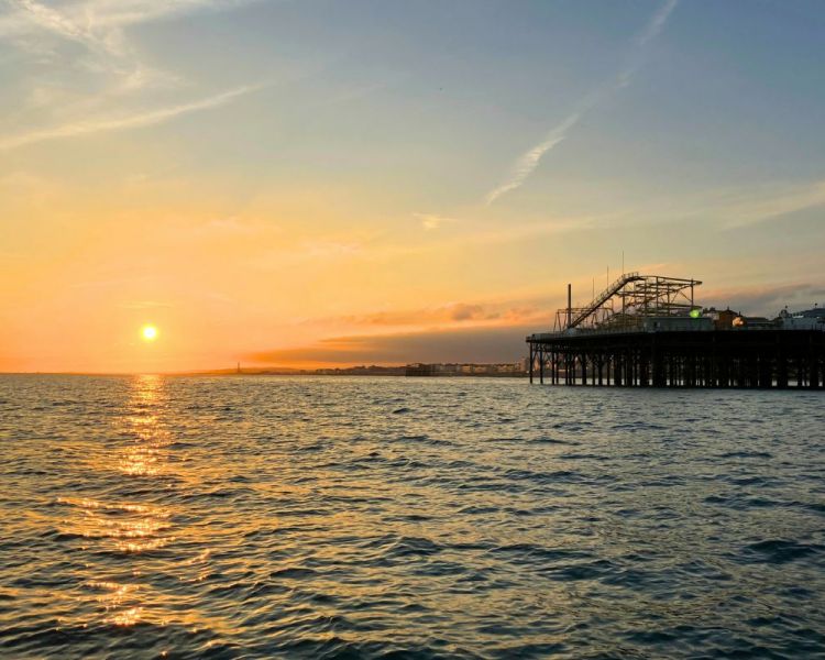 View of brighton pier with the sun setting