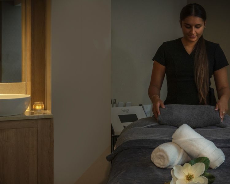 The spa therapist preparing the treatment room at the q hotels spa hotel in oxford