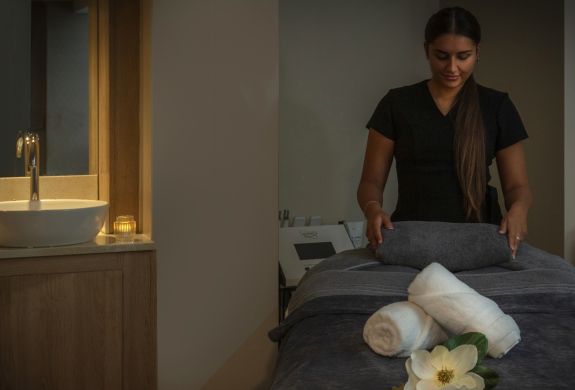 The spa therapist preparing the treatment room at the q hotels spa hotel in oxford