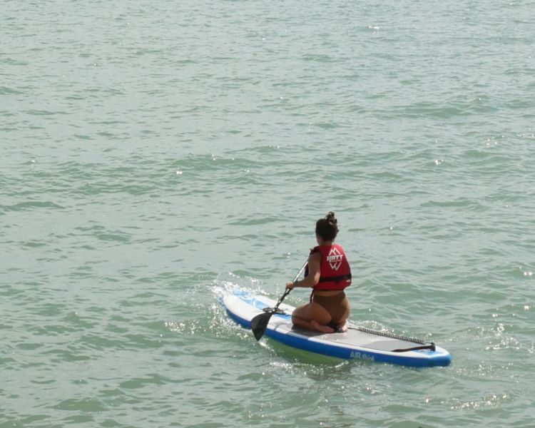 A solo woman paddle boarding at SUP Hatt Adventures