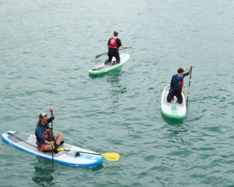3 people paddle boarding at SUP Hatt Adventures