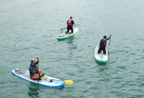 3 people paddle boarding at SUP Hatt Adventures