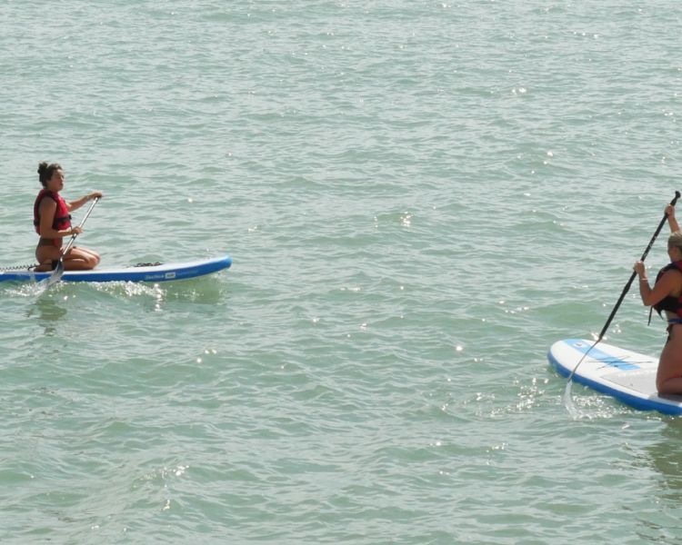 2 women paddle boarding at SUP Hatt Adventures
