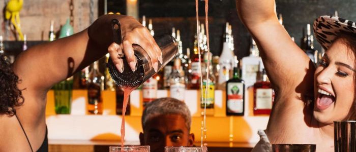 2 female bartenders pouring cocktails