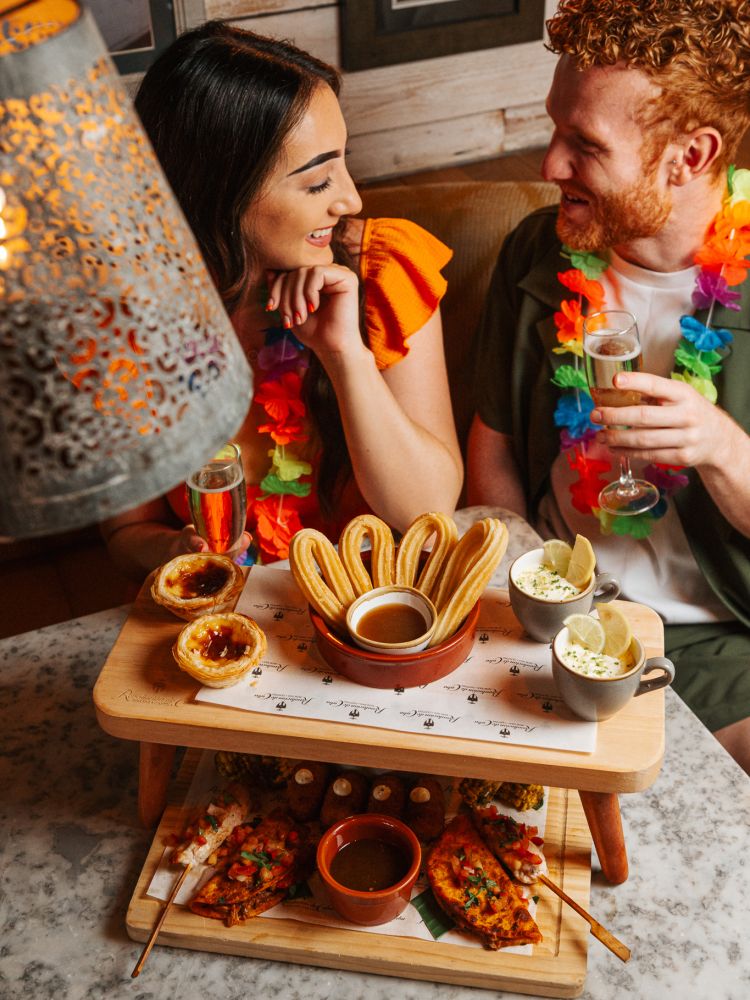 a man and a woman at a cuban inspired afternoon tea experience at revolucion de cuba