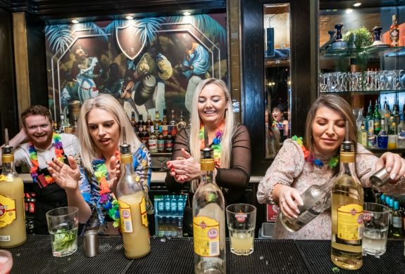 three ladies mixing cocktails on a cocktail masterclass at revolucion de cuba