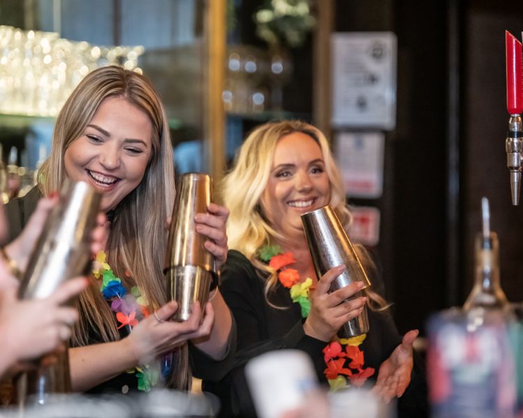 ladies shaking cocktails on a cocktail masterclass at revolucion de cuba