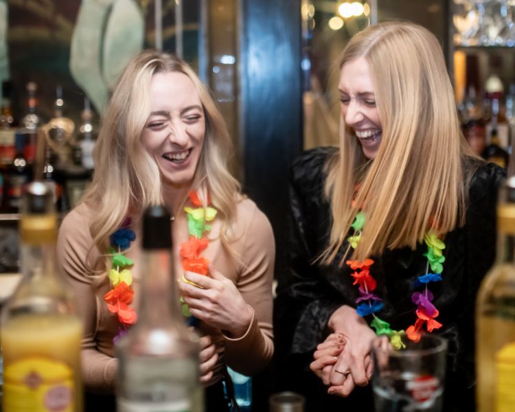 two ladies laughing on a cocktail masterclass at revolucion de cuba