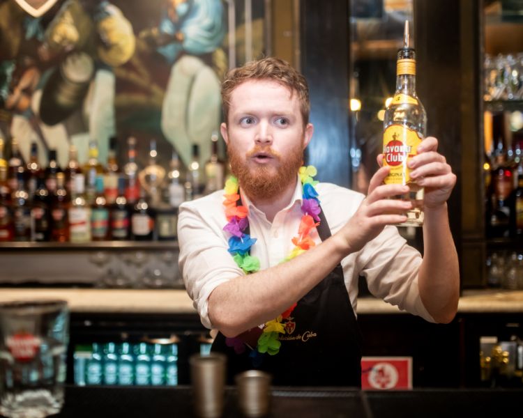 a bartender showing how to make a cocktail on a cocktail masterclass at revolucion de cuba