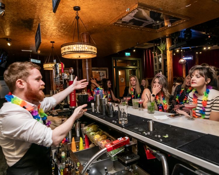 a bartender explaining cocktails on a cocktail masterclass at revolucion de cuba