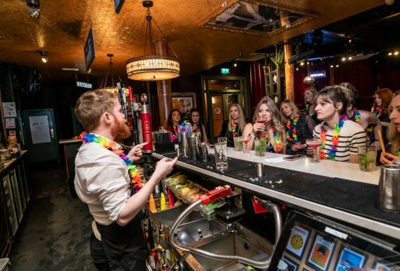 people watching  bartender behind the bar on a cocktail masterclass at revolucion de cuba