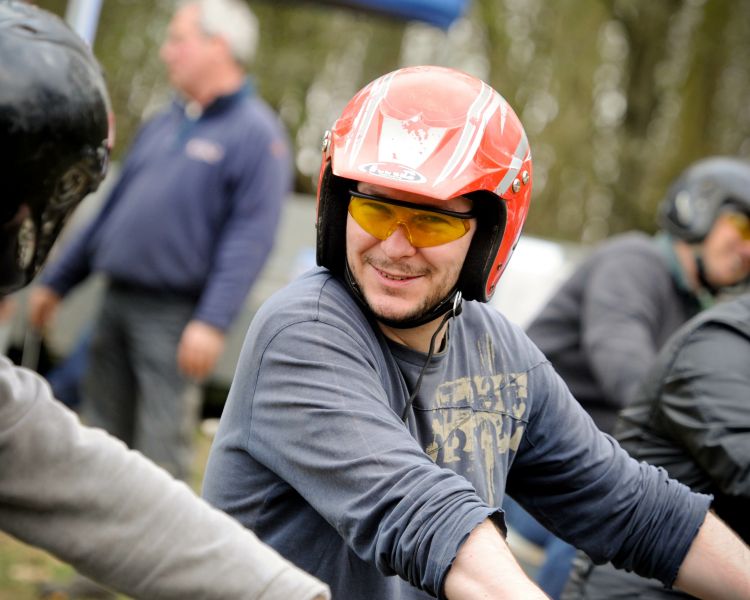 Close up of a man wearing a helmet and safety goggles on a Quad Bike