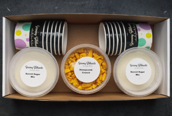 an ice cream making kit in a box including pots, toppings and ice-cream