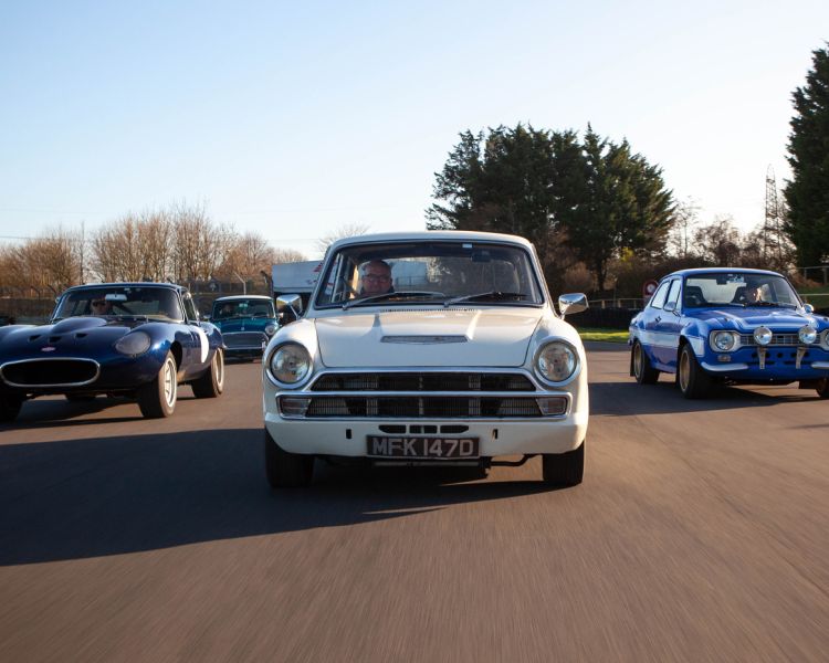 british classic cars driving along a race track as part of a driving experience day gift