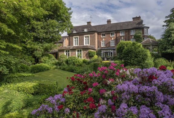 a view of a country hotel with its gardens in bloom in ironbridge in shropshire