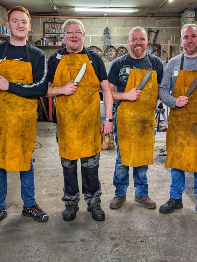 Group of men holding a knife