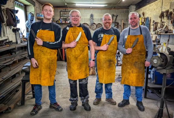 Group of men holding a knife