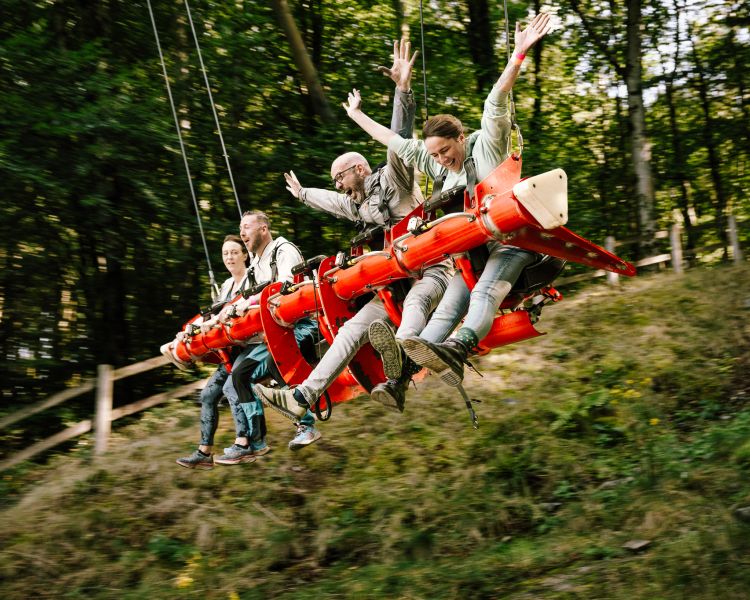 people on the zip world skyride in wales