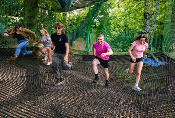 people running on the nets at zip world treetop nets