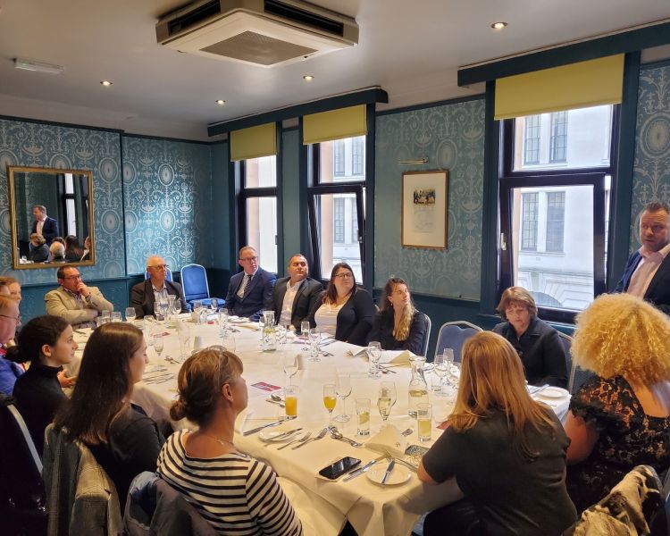 people sat at a long table for an introduction to the james bond london tour