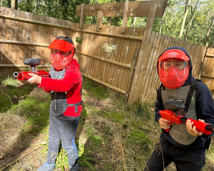 Boys in red masks with paint guns