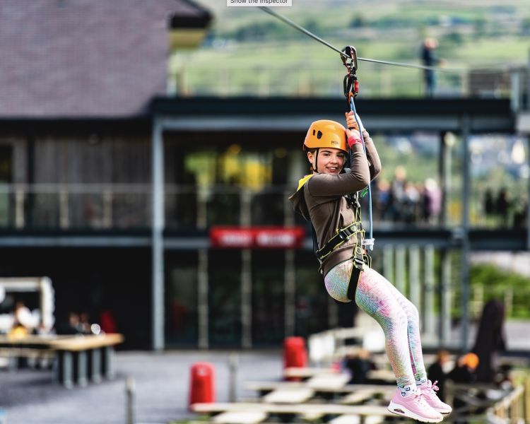 young girl on the zip world quarry flyer zip line