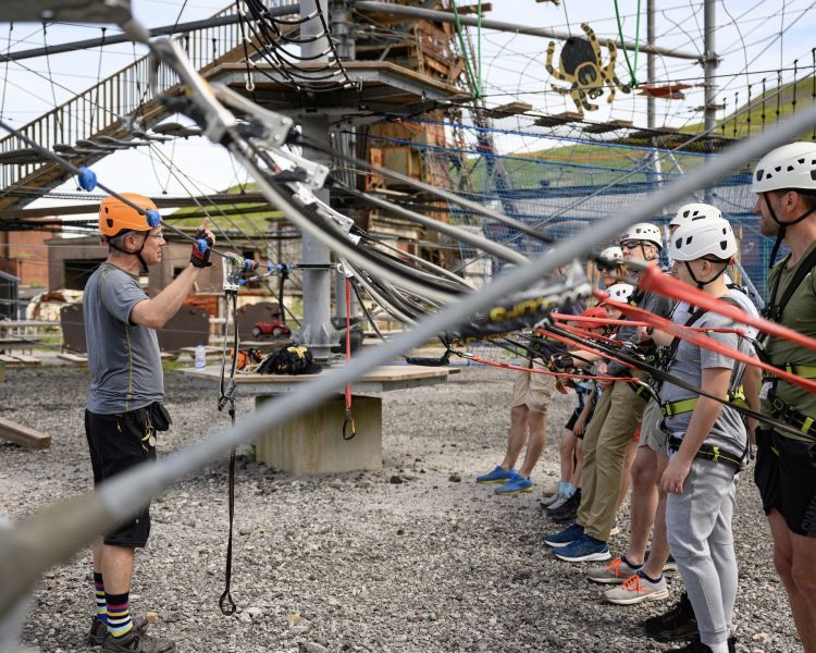 people having a safety briefing before going on the zip world tower climber in south wales