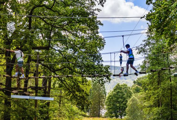 people on the zip world full trek manchester treetop obstacle course
