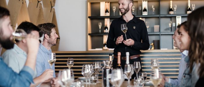 group of people enjoying a wine tasting on a tour of gusbourne estate